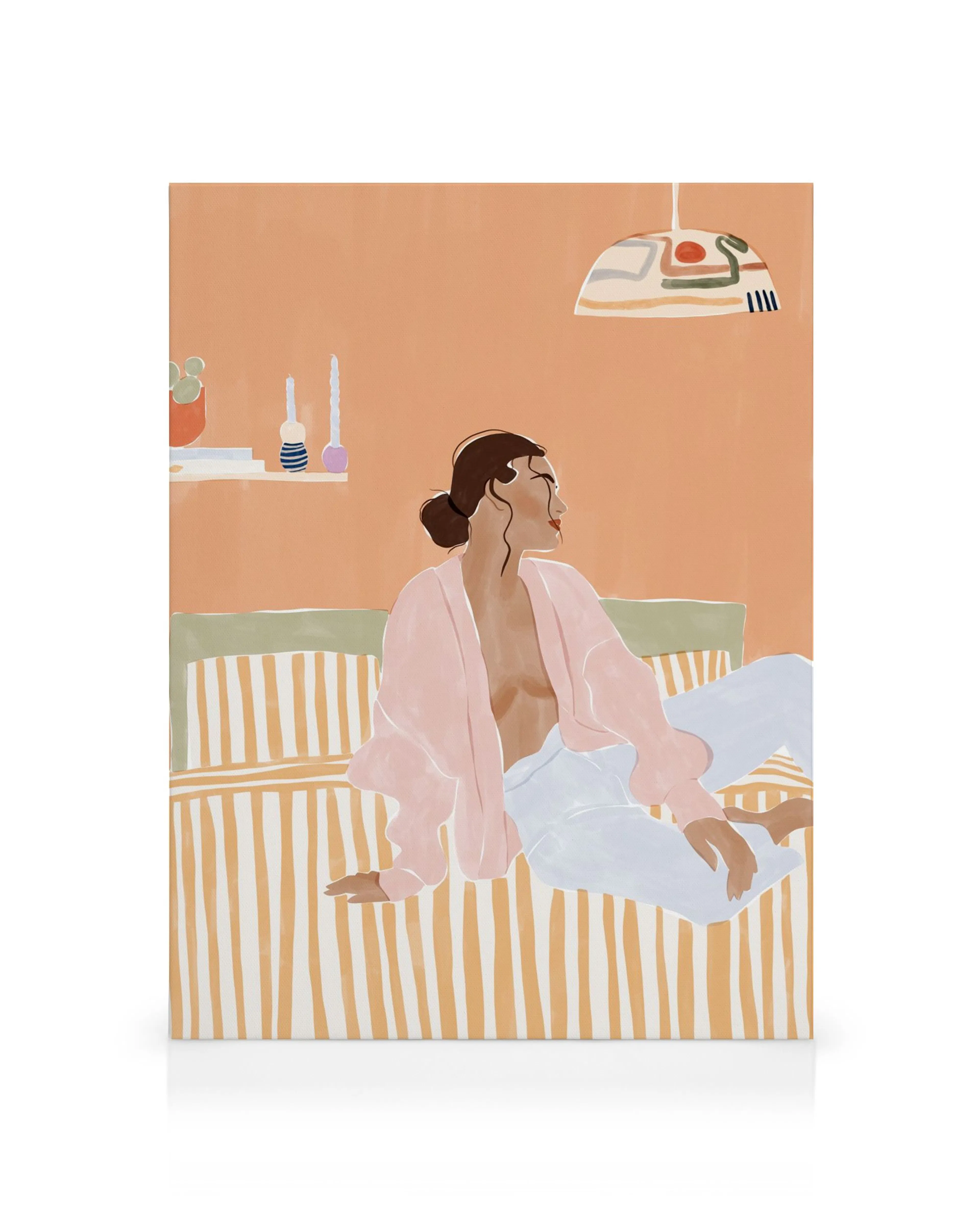Woman lounging on striped bedding, pink robe, peach wall art, bedroom decor.