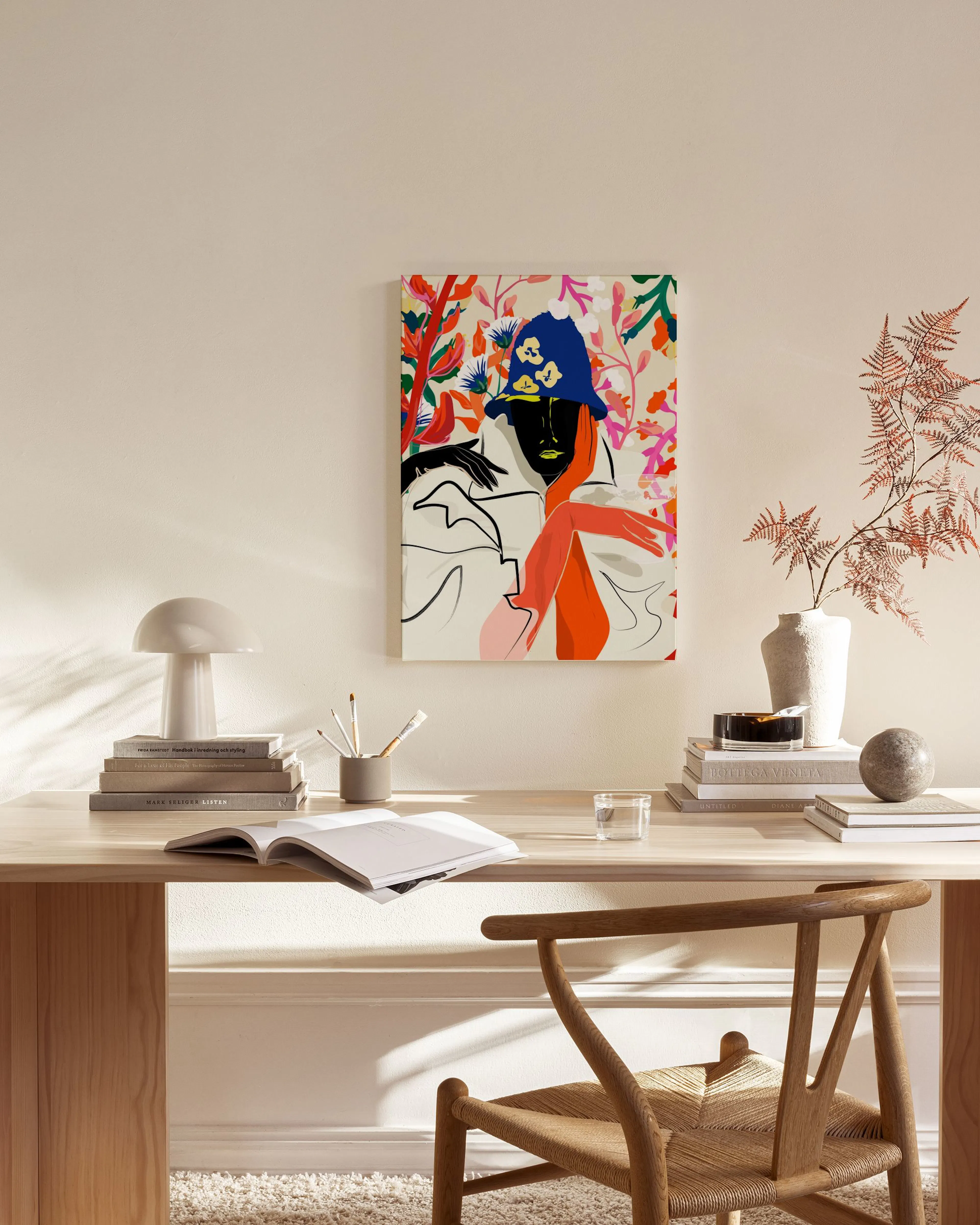 A vibrant canvas art featuring a woman with blue hair and orange sleeves, surrounded by colorful foliage, hanging in a modern li