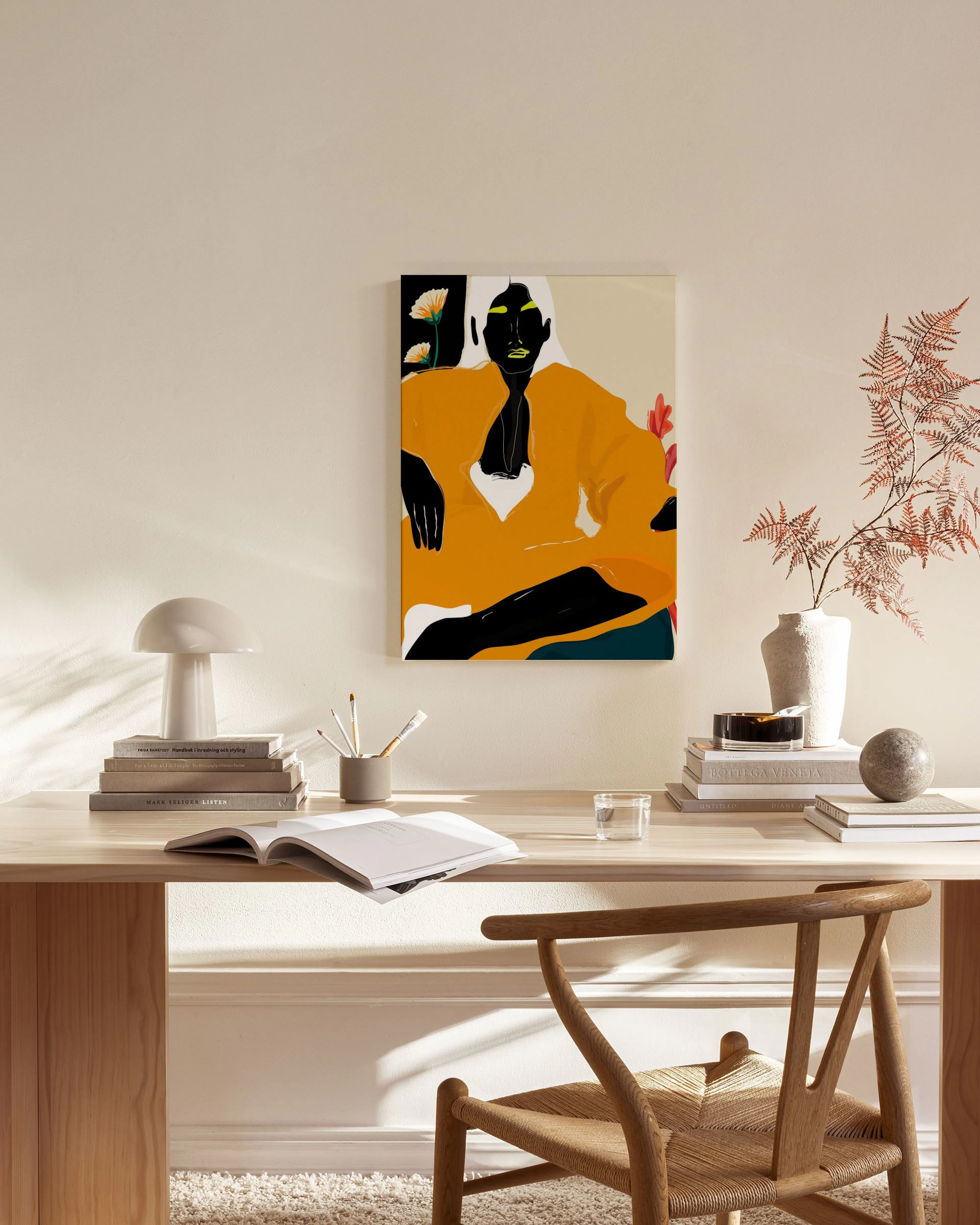 Abstract canvas print of a figure in a mustard yellow top, with black skin and white hair, in a modern living room.