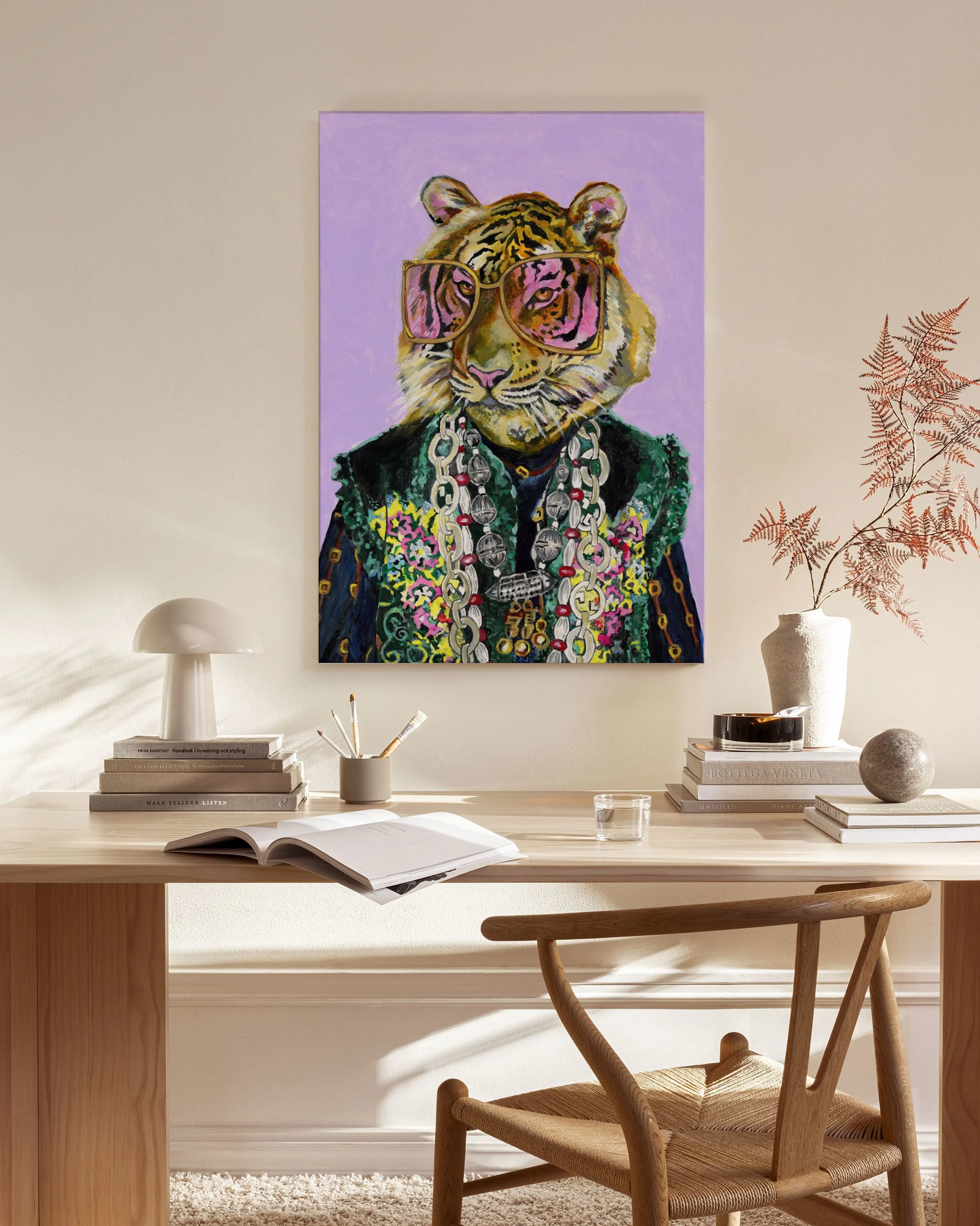 A colorful tiger portrait, wearing sunglasses and a patterned coat, hanging in a modern living room above a wooden console table