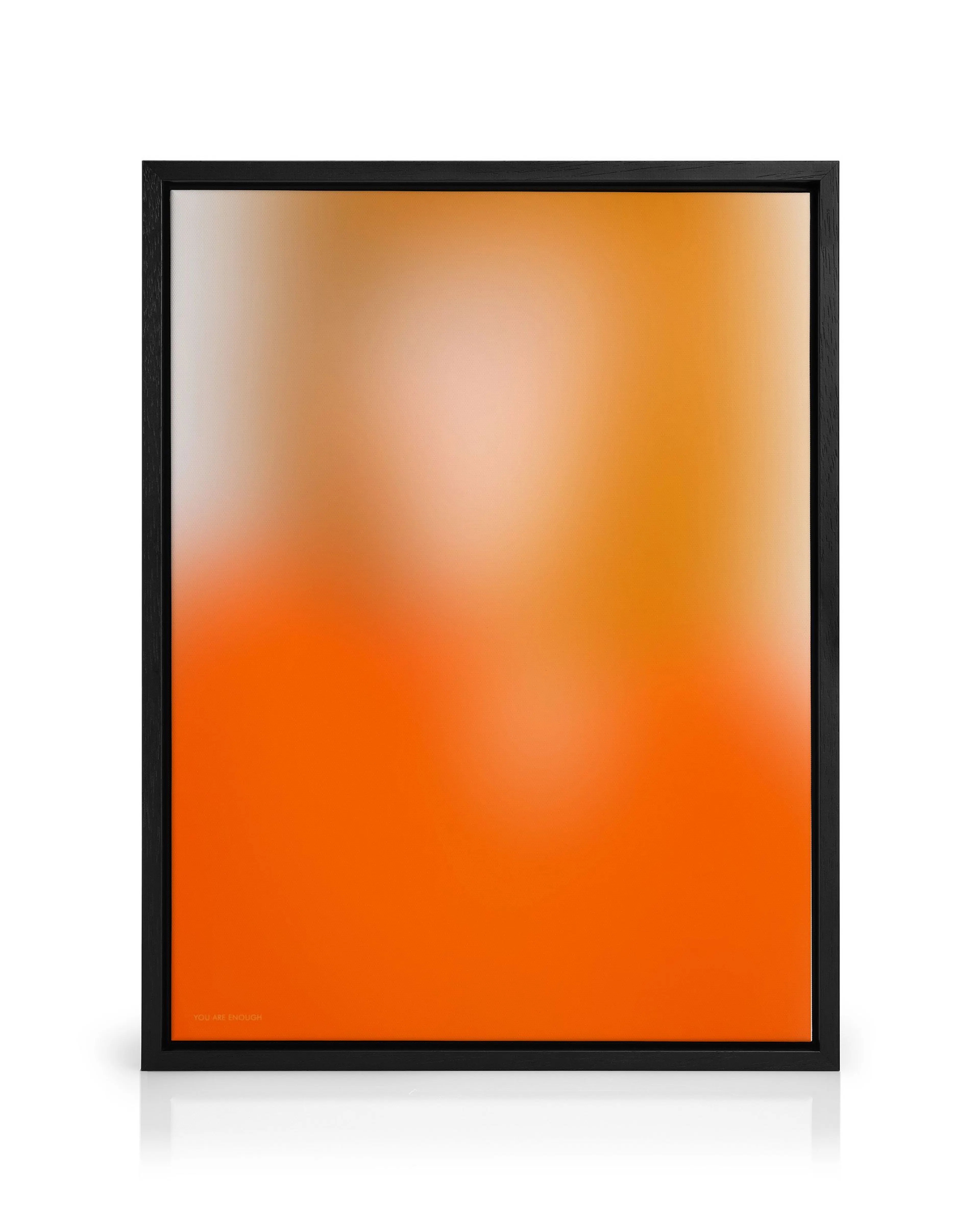 A canvas print featuring a vibrant orange gradient fading to a lighter orange and peach at the top, with YOU ARE ENOUGH text in 