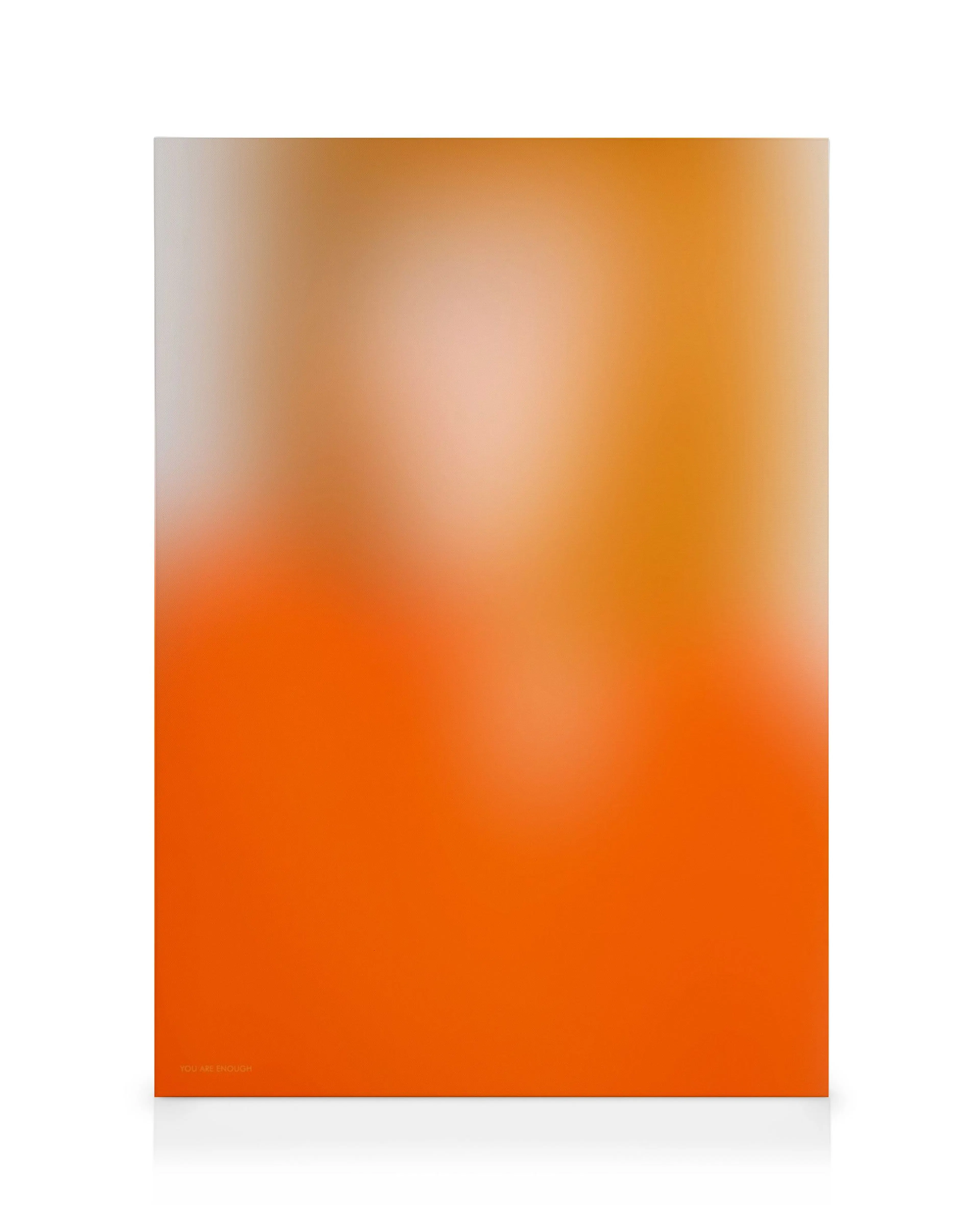 A canvas print with a vibrant orange and warm beige gradient, featuring the subtle text YOU ARE ENOUGH at the bottom left.