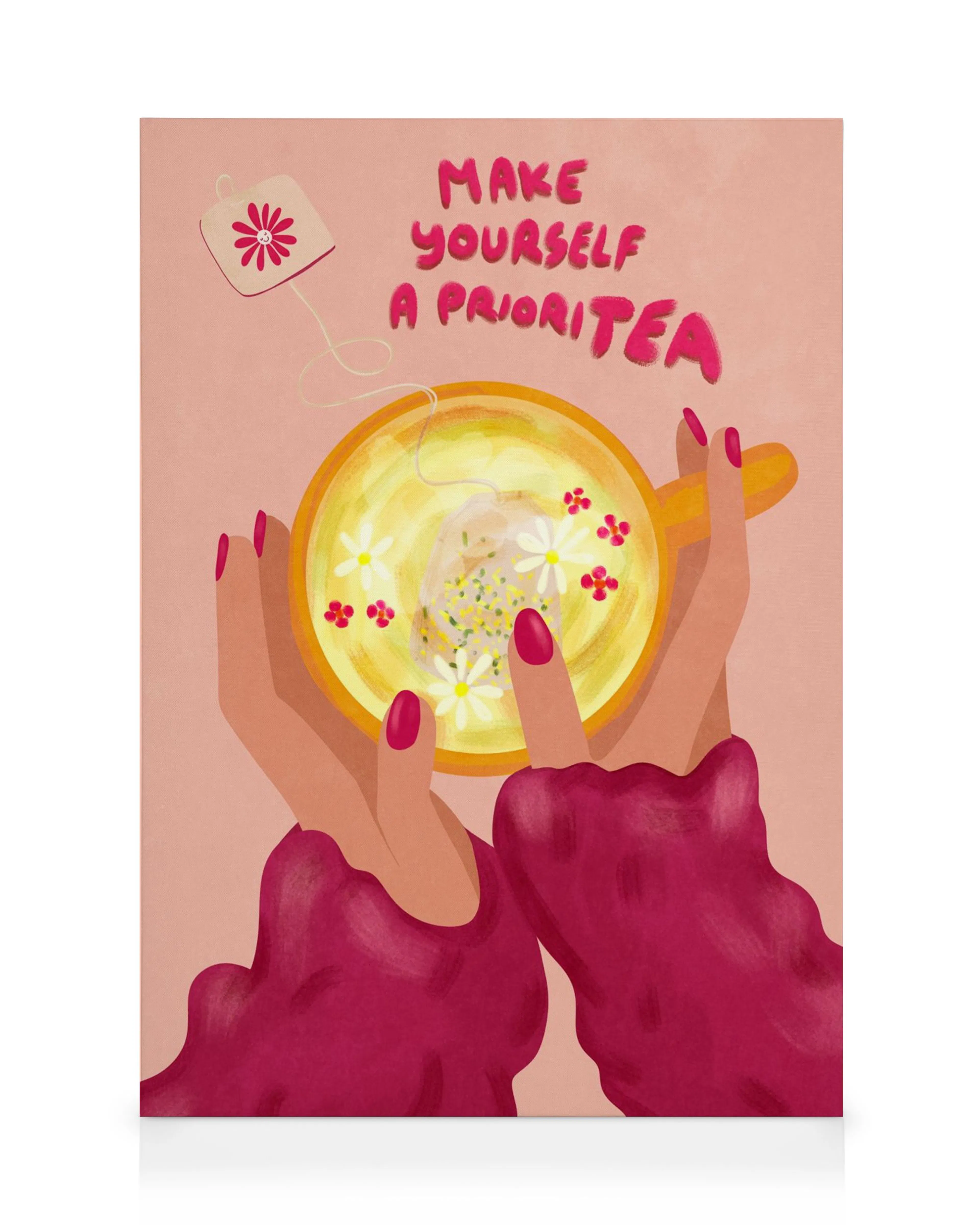 A canvas print featuring two hands holding a yellow tea cup with flowers, with the text Make Yourself A Prioritea.