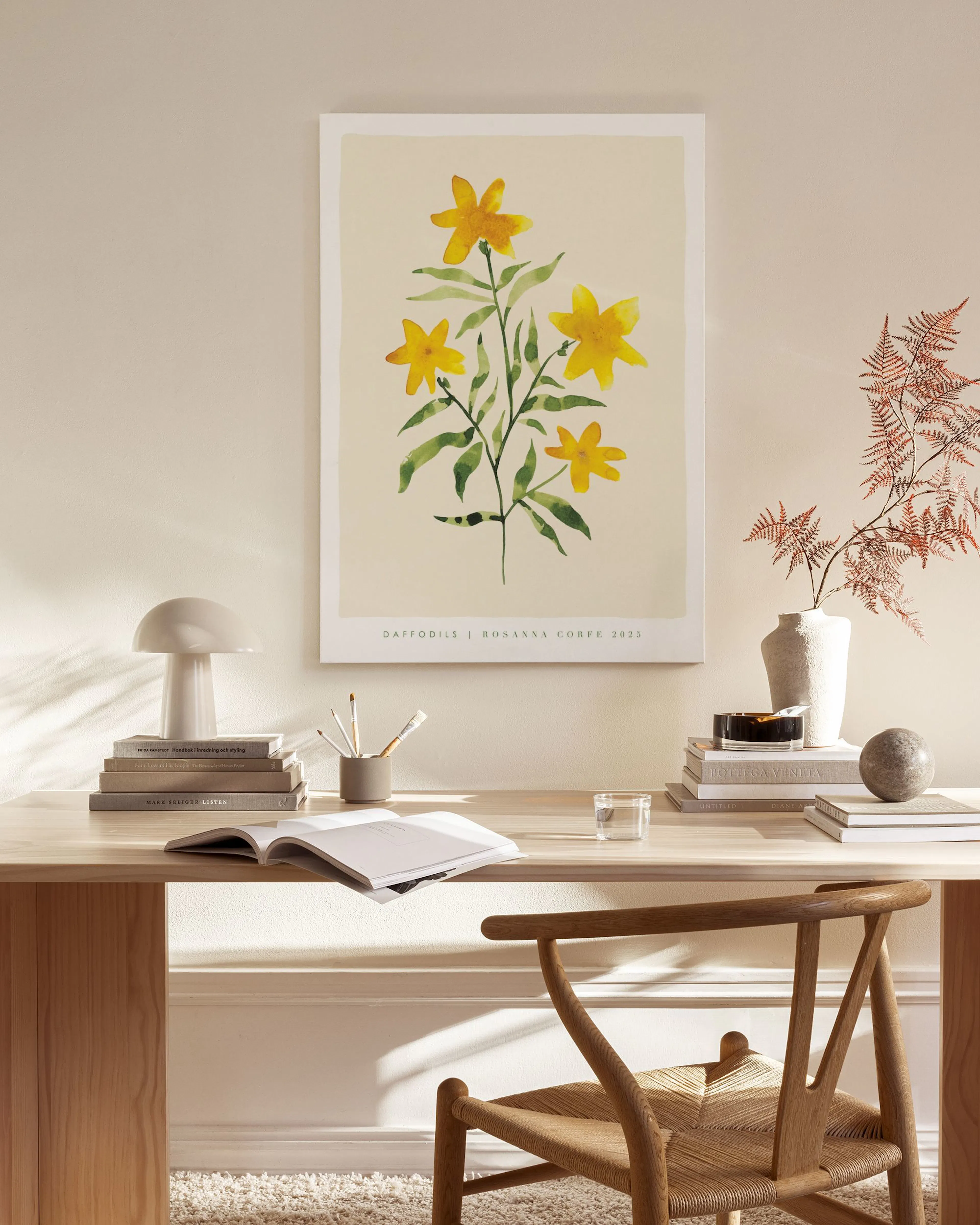A botanical canvas print of yellow daffodils with green leaves, displayed above a wooden console table in a minimalist living ro