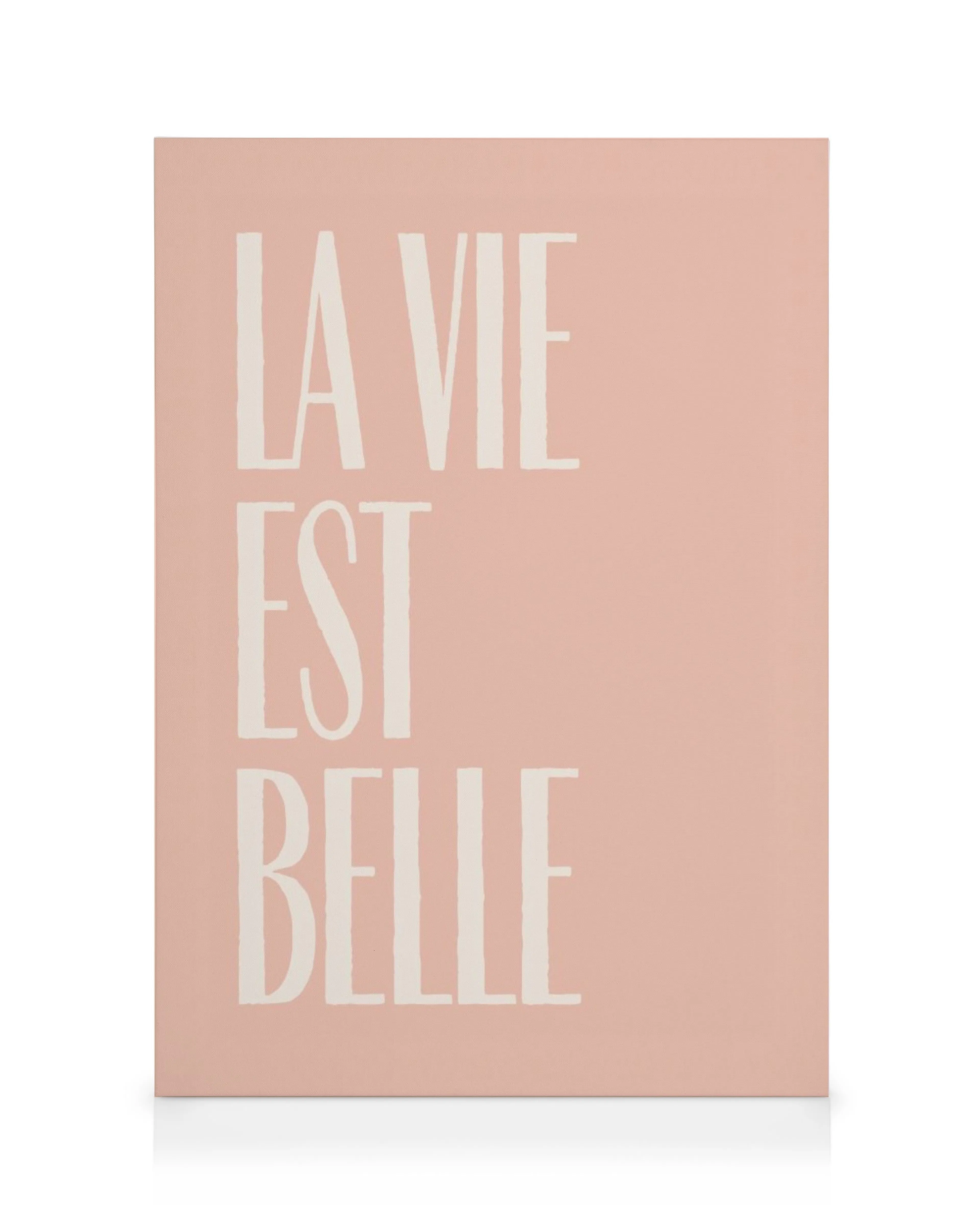La Vie Est Belle text canvas with large, cream block letters on a soft pink background.