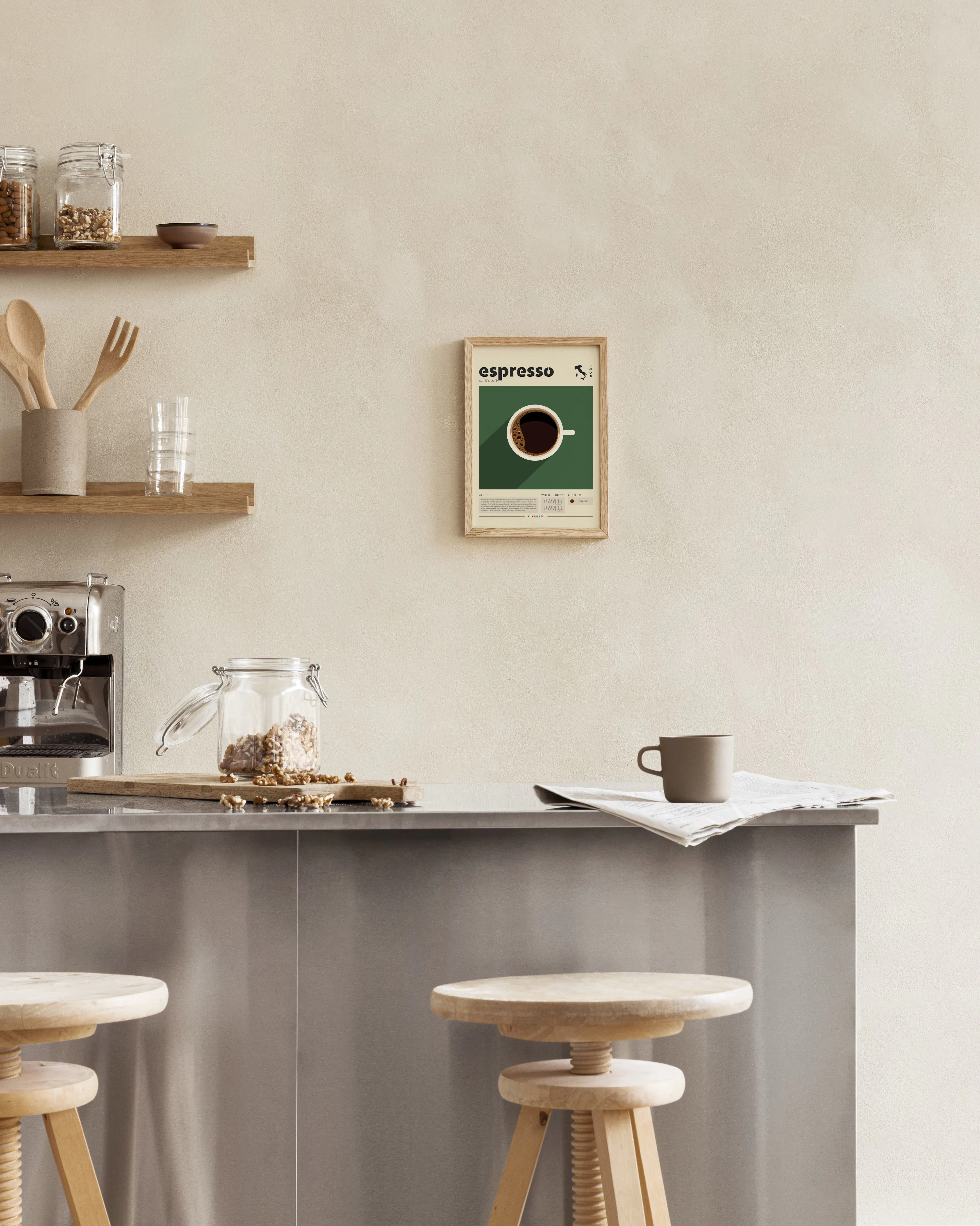 Espresso coffee print featuring a white cup on a green background, hanging in a modern kitchen above a counter with stools.